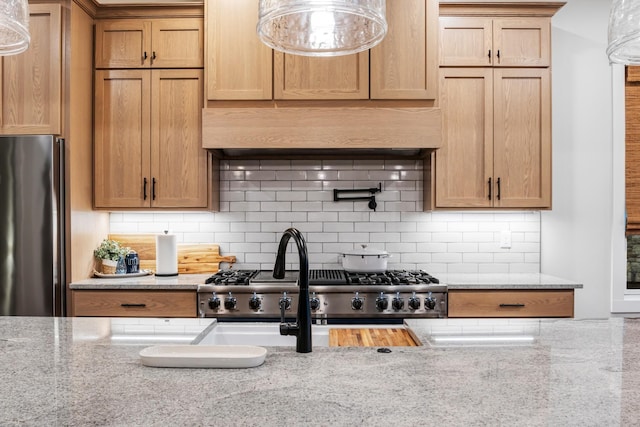 314 N Porter St, Winchester, TN 37398 - kitchen featuring freestanding refrigerator, tasteful backsplash, light stone countertops, and custom exhaust hood