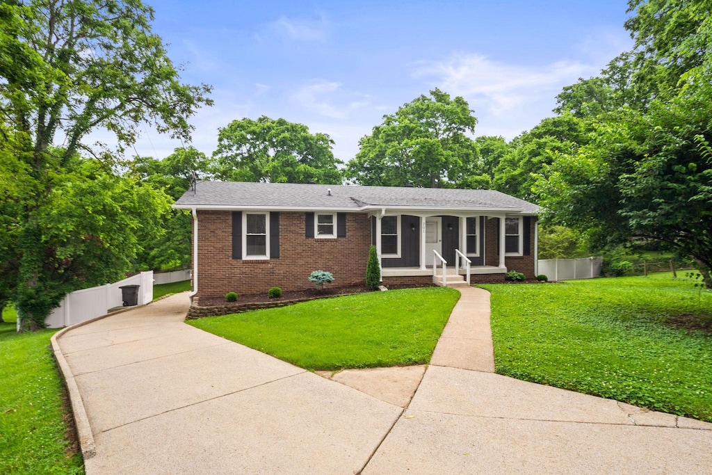 201 Gates Dr, Hendersonville, TN 37075 - single story home with brick siding, a porch, driveway, and roof with shingles