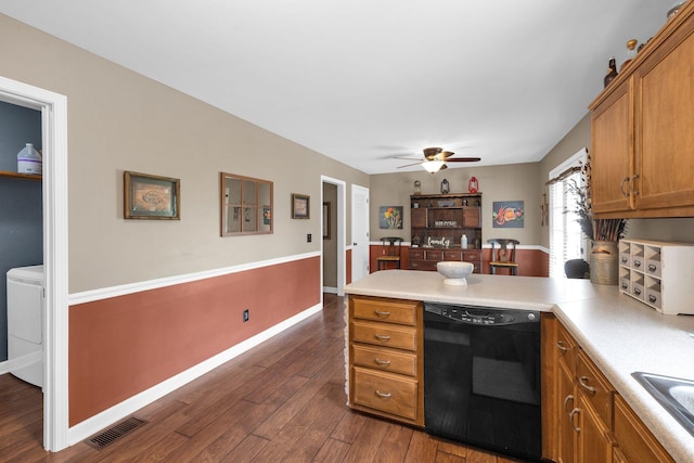 1325 Branchside Ct, Thompsons Station, TN 37179 - kitchen with black dishwasher, a peninsula, brown cabinetry, a ceiling fan, and dark wood-style flooring