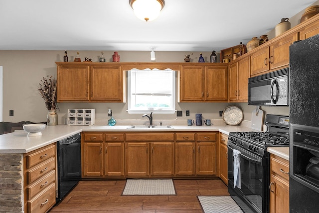 1325 Branchside Ct, Thompsons Station, TN 37179 - kitchen featuring black appliances, a sink, a peninsula, and light countertops