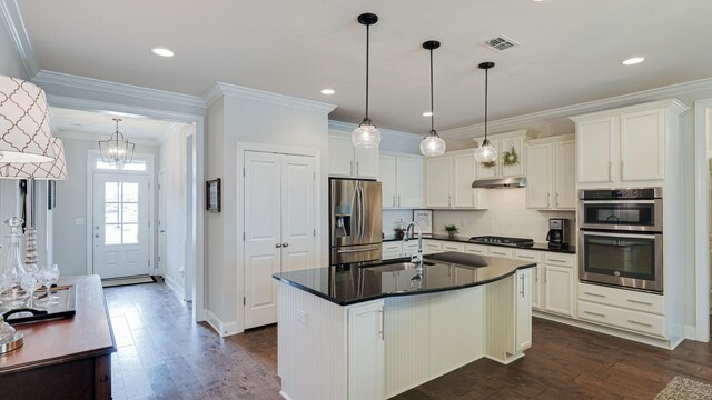 4724 Kingdom Dr, Murfreesboro, TN 37128 - kitchen featuring stainless steel appliances, dark countertops, dark wood-style floors, under cabinet range hood, and ornamental molding