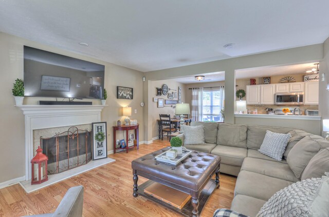 1753 Stone Hollow Ct, Hermitage, TN 37076 - living room with light wood-style floors, a high end fireplace, and baseboards