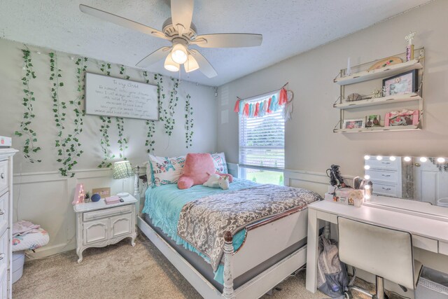 1753 Stone Hollow Ct, Hermitage, TN 37076 - bedroom with light carpet, a textured ceiling, a wainscoted wall, ceiling fan, and a decorative wall