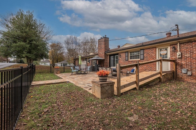 111 Proffitt St, Carthage, TN 37030 - back of house featuring a chimney, brick siding, a wooden deck, and a patio