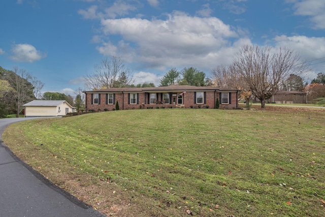 111 Proffitt St, Carthage, TN 37030 - ranch-style house with brick siding, a front lawn, and a garage