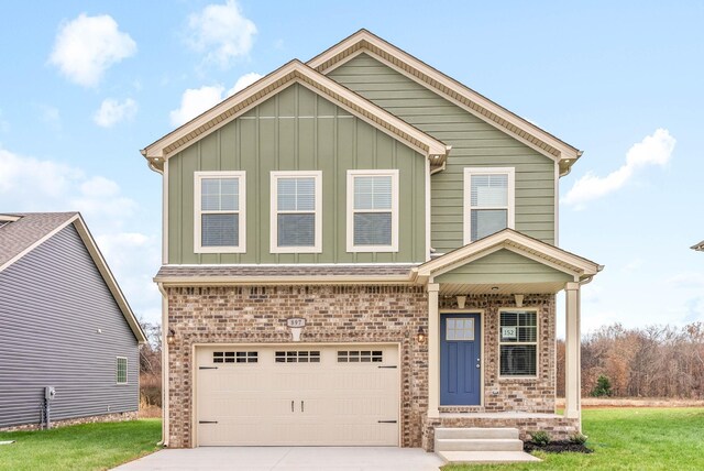 230 Cardinal Crk, Clarksville, TN 37040 - view of front facade with a garage, board and batten siding, driveway, and brick siding