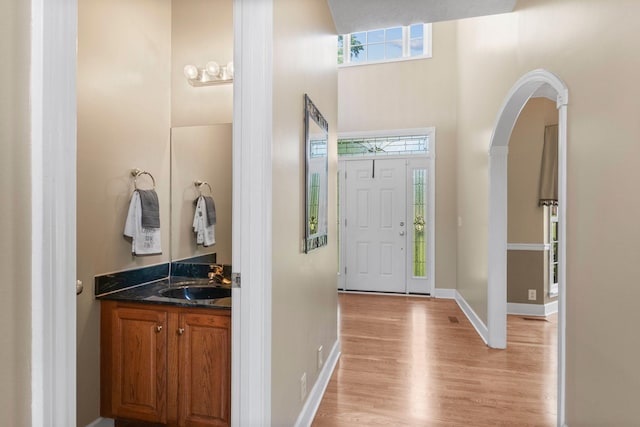 134 Blackberry Ln, Murfreesboro, TN 37130 - entryway featuring light wood-style flooring, arched walkways, a high ceiling, and baseboards