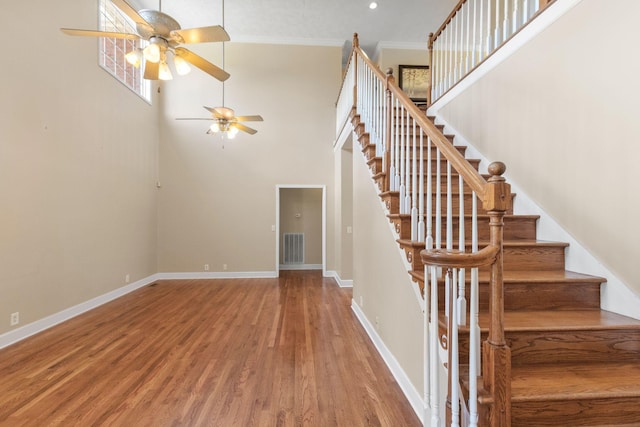134 Blackberry Ln, Murfreesboro, TN 37130 - staircase featuring ceiling fan, wood finished floors, baseboards, a towering ceiling, and ornamental molding