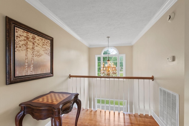 134 Blackberry Ln, Murfreesboro, TN 37130 - hallway with a textured ceiling, wood finished floors, a chandelier, and ornamental molding