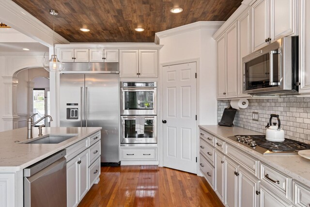1505 Charleston Park Dr, Spring Hill, TN 37174 - kitchen featuring stainless steel appliances, a sink, wood ceiling, arched walkways, and hanging light fixtures