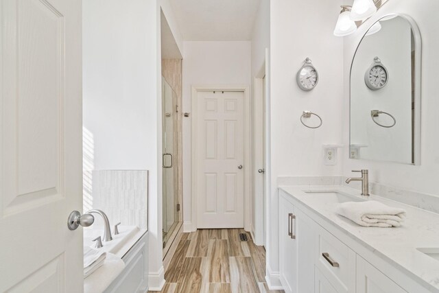 1505 Charleston Park Dr, Spring Hill, TN 37174 - full bath featuring a shower stall, a garden tub, double vanity, and wood finished floors