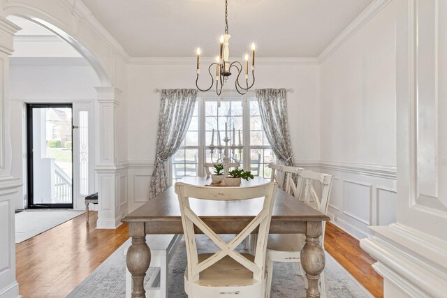 1505 Charleston Park Dr, Spring Hill, TN 37174 - dining space with wood finished floors, arched walkways, a chandelier, a decorative wall, and crown molding