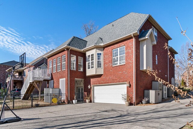 1505 Charleston Park Dr, Spring Hill, TN 37174 - view of front of home with asphalt driveway, brick siding, fence, an attached garage, and roof with shingles