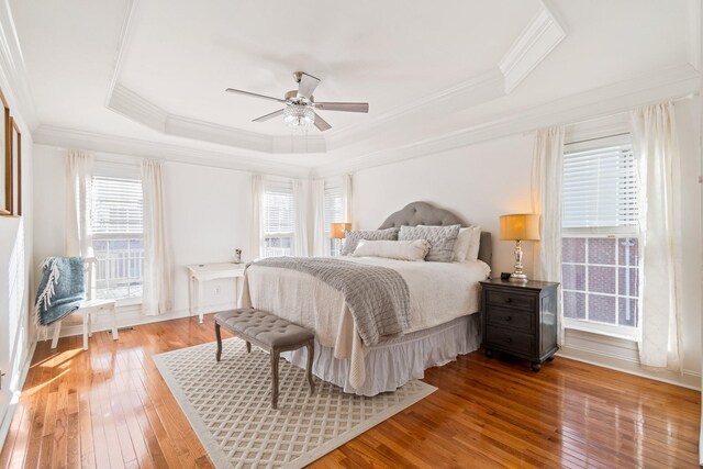 1505 Charleston Park Dr, Spring Hill, TN 37174 - bedroom with light wood-style flooring, a tray ceiling, ornamental molding, ceiling fan, and baseboards