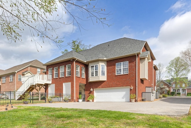 1505 Charleston Park Dr, Spring Hill, TN 37174 - back of house featuring brick siding, concrete driveway, an attached garage, fence, and central air condition unit