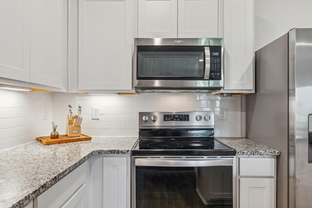 105 Grayson Cir, Chapel Hill, TN 37034 - kitchen with appliances with stainless steel finishes, backsplash, white cabinets, and light stone counters