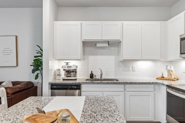 105 Grayson Cir, Chapel Hill, TN 37034 - kitchen featuring a sink, appliances with stainless steel finishes, white cabinets, and decorative backsplash