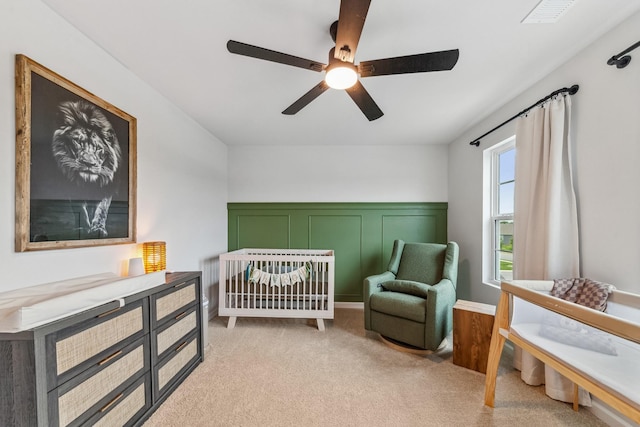 105 Grayson Cir, Chapel Hill, TN 37034 - bedroom with a crib, ceiling fan, light colored carpet, and a wainscoted wall