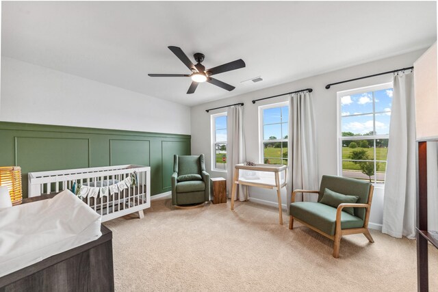105 Grayson Cir, Chapel Hill, TN 37034 - bedroom with light colored carpet, a crib, a ceiling fan, and a decorative wall