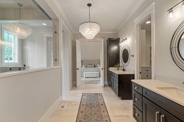 4617 Delta Springs Ln, Franklin, TN 37064 - full bath with a chandelier, two vanities, baseboards, and ornamental molding