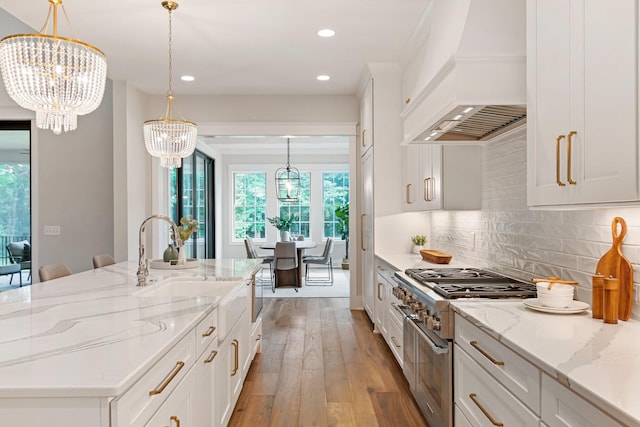 4617 Delta Springs Ln, Franklin, TN 37064 - kitchen featuring high end range, premium range hood, a chandelier, recessed lighting, and white cabinetry