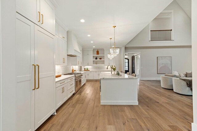 4617 Delta Springs Ln, Franklin, TN 37064 - kitchen with premium range hood, open shelves, stainless steel stove, white cabinetry, and recessed lighting