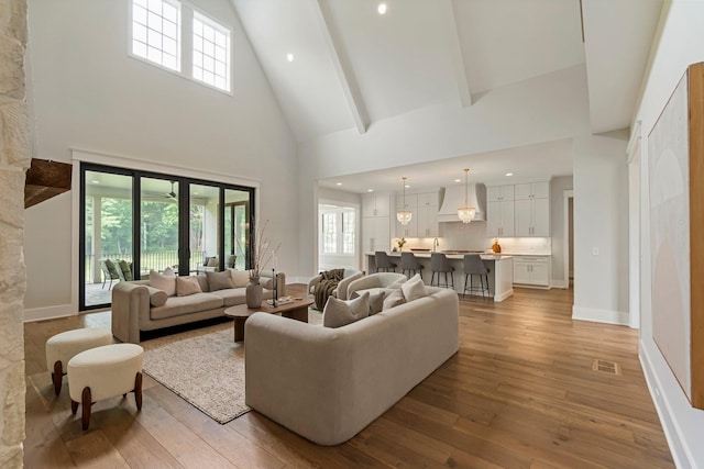 4617 Delta Springs Ln, Franklin, TN 37064 - living area featuring high vaulted ceiling, light wood finished floors, recessed lighting, and baseboards