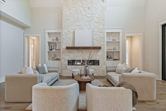 4617 Delta Springs Ln, Franklin, TN 37064 - living area with a high ceiling, wood finished floors, a fireplace, built in shelves, and baseboards
