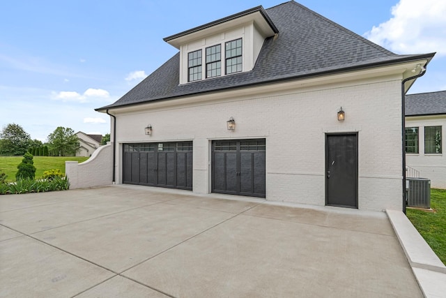 4617 Delta Springs Ln, Franklin, TN 37064 - view of front of house featuring central AC unit, a shingled roof, driveway, and brick siding