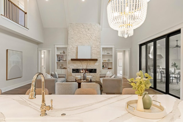 4617 Delta Springs Ln, Franklin, TN 37064 - living area with high vaulted ceiling, baseboards, built in features, wood finished floors, and a large fireplace