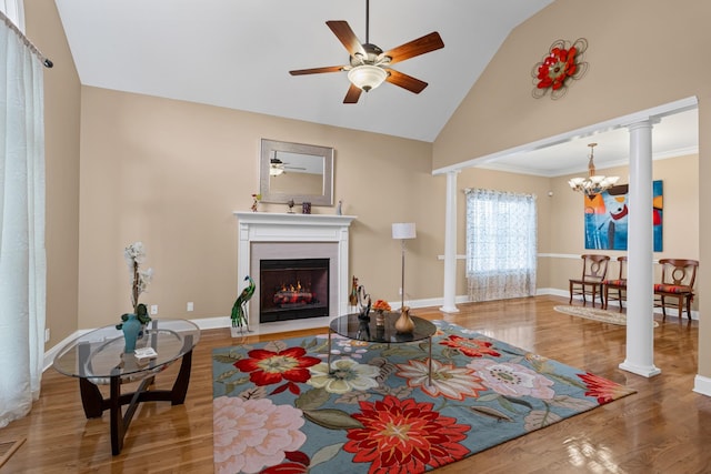 6769 Cold Stream Dr, Nashville, TN 37221 - living area featuring ceiling fan, decorative columns, a fireplace with flush hearth, wood finished floors, and a chandelier