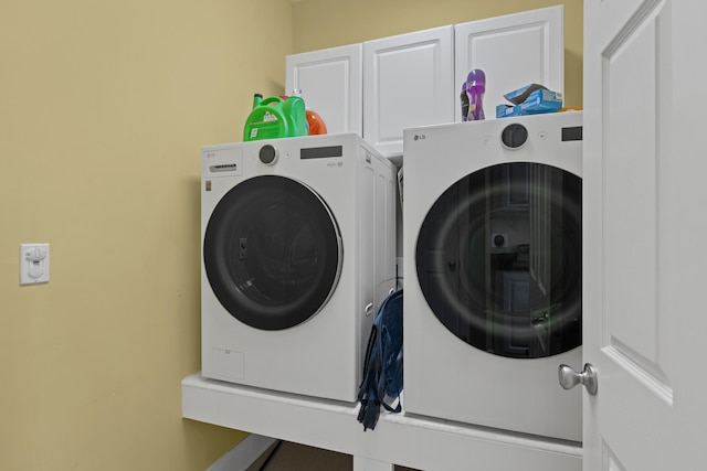 6769 Cold Stream Dr, Nashville, TN 37221 - clothes washing area featuring independent washer and dryer and cabinet space