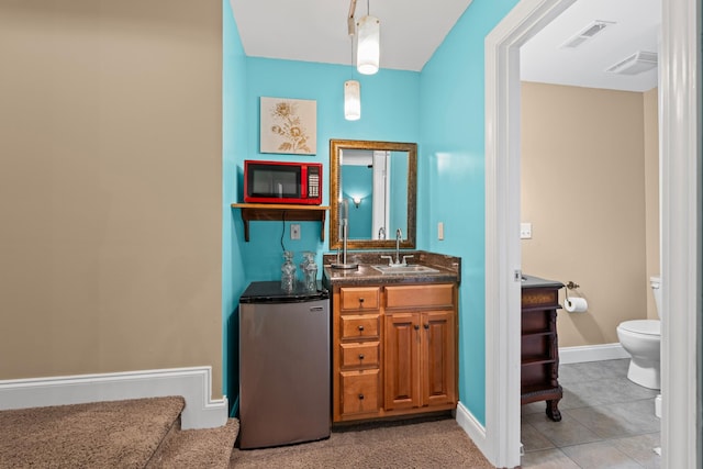 6769 Cold Stream Dr, Nashville, TN 37221 - bathroom with toilet, vanity, baseboards, and tile patterned flooring