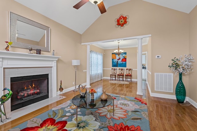 6769 Cold Stream Dr, Nashville, TN 37221 - living room with a chandelier, wood finished floors, ceiling fan, a fireplace with flush hearth, and vaulted ceiling