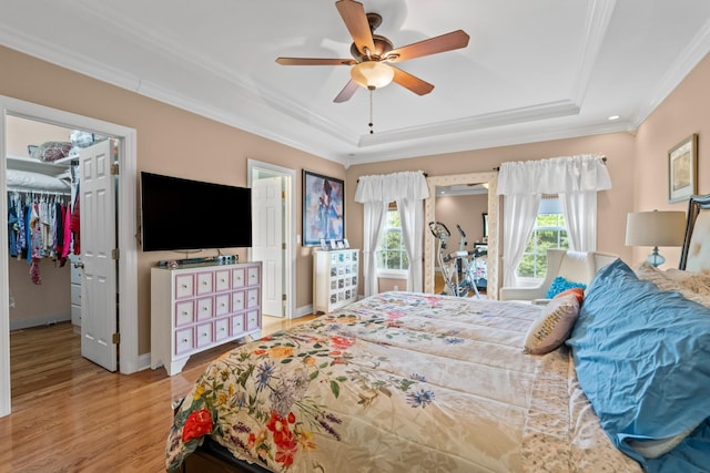 6769 Cold Stream Dr, Nashville, TN 37221 - bedroom featuring a raised ceiling, crown molding, wood finished floors, a spacious closet, and ceiling fan