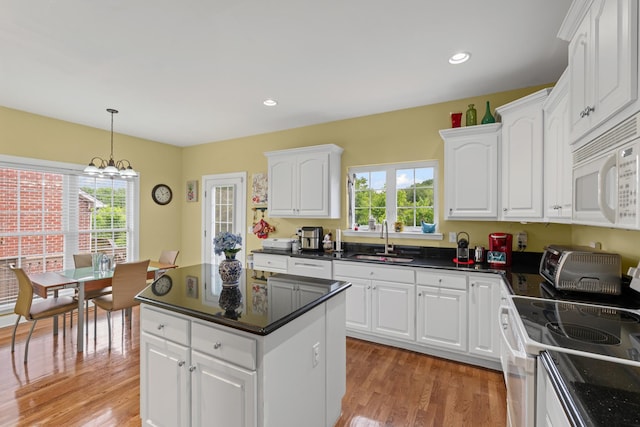 6769 Cold Stream Dr, Nashville, TN 37221 - kitchen featuring white appliances, a sink, light wood finished floors, dark countertops, and recessed lighting