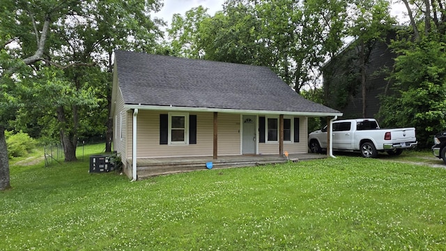500 E 17th St, Columbia, TN 38401 - view of front of property featuring a porch, a front yard, central AC unit, and roof with shingles