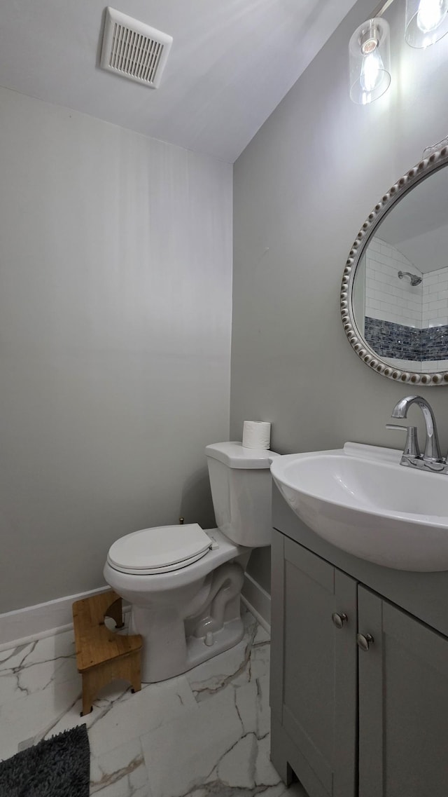 500 E 17th St, Columbia, TN 38401 - bathroom with baseboards, toilet, vanity, and marble finish floors