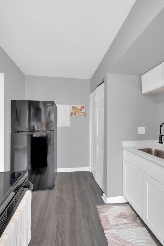 1301 Neelys Bend Rd Unit A10, Madison, TN 37115 - kitchen with black appliances, a sink, wood finished floors, white cabinets, and baseboards