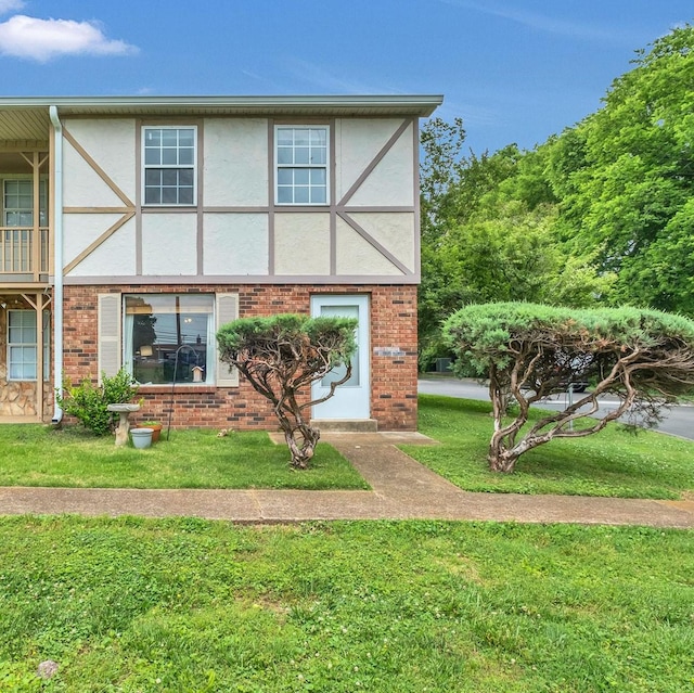 1301 Neelys Bend Rd Unit A10, Madison, TN 37115 - view of front of home with a front lawn, brick siding, and stucco siding