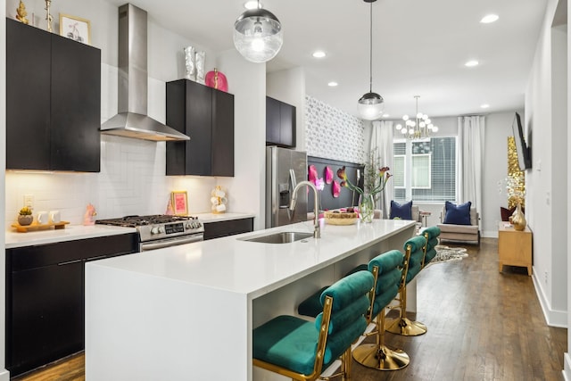 2910 Felicia St Unit 18, Nashville, TN 37209 - kitchen featuring wall chimney range hood, a sink, appliances with stainless steel finishes, light countertops, and a center island with sink