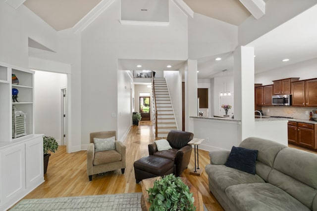 4019 Fremantle Cir, Spring Hill, TN 37174 - living room with light wood finished floors, stairs, baseboards, and high vaulted ceiling