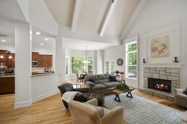 4019 Fremantle Cir, Spring Hill, TN 37174 - living room with light wood-style flooring, healthy amount of natural light, high vaulted ceiling, a fireplace, and beam ceiling