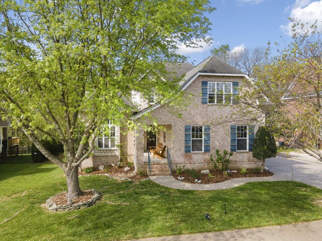 4019 Fremantle Cir, Spring Hill, TN 37174 - view of front of home featuring brick siding, a front lawn, and a shingled roof