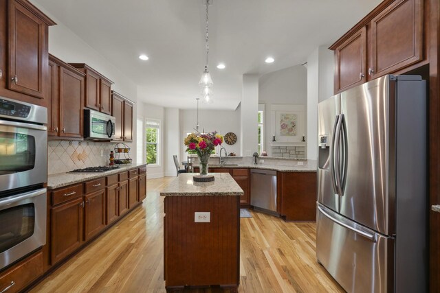 4019 Fremantle Cir, Spring Hill, TN 37174 - kitchen featuring appliances with stainless steel finishes, a sink, backsplash, light wood-type flooring, and recessed lighting