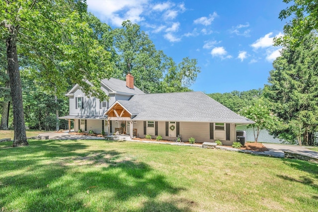 106 Lakewood Dr, Dickson, TN 37055 - view of front of house with covered porch, a chimney, a front yard, and a shingled roof