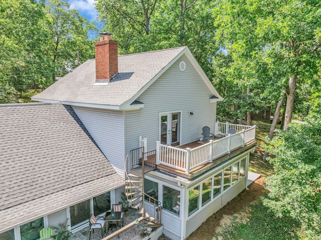 106 Lakewood Dr, Dickson, TN 37055 - rear view of property featuring roof with shingles, a chimney, french doors, a sunroom, and a deck