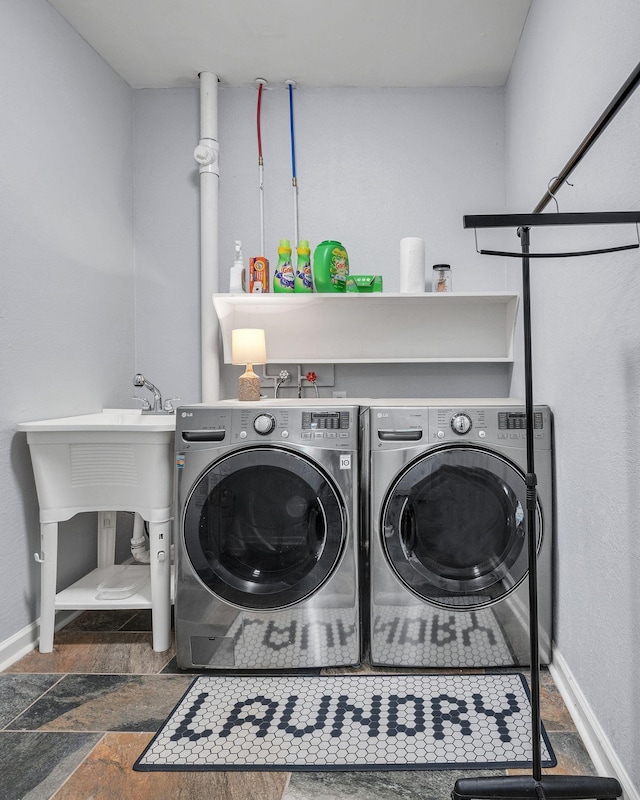 106 Lakewood Dr, Dickson, TN 37055 - laundry room with washing machine and dryer, baseboards, and stone finish flooring