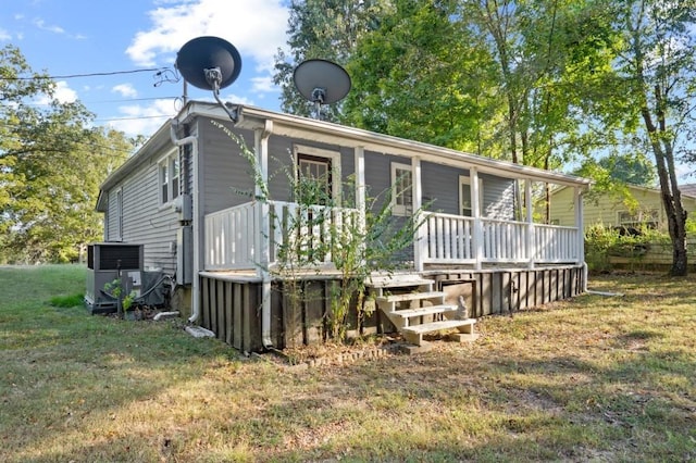 119 Wynns Ferry Rd, Dover, TN 37058 - back of house featuring a lawn, central AC unit, and a porch