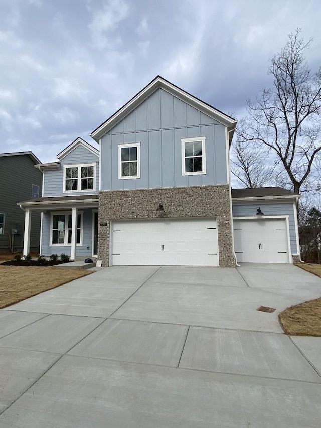 2321 Aniston Ct, Antioch, TN 37013 - view of front of home with concrete driveway, a garage, and board and batten siding